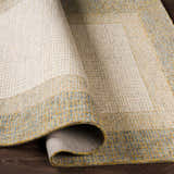 Close-up of the hand-tufted Tandayag Area Rug. Cream, sage, and light beige wool rug with a solid and striped contemporary design. Fold
