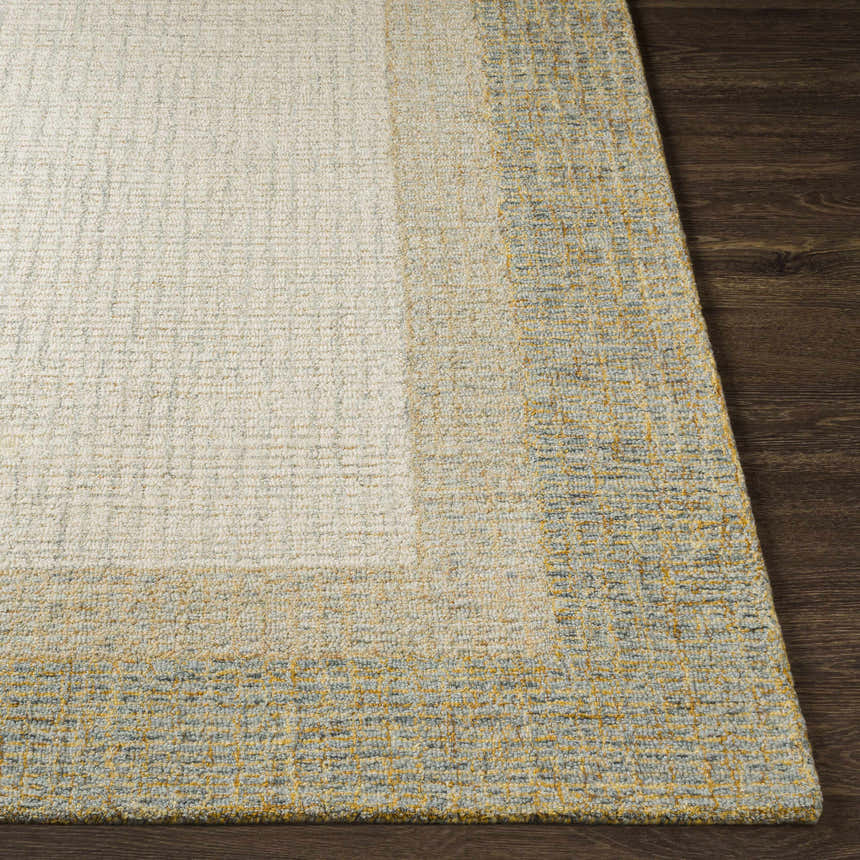 Close-up of the hand tufted Tandayag Area Rug. Cream, light beige, and dusty sage wool rug with a striped design. Front