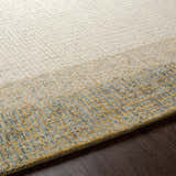 Close-up of the hand-tufted Tandayag Area Rug. Cream, light beige, and sage wool rug with a subtle striped pattern. Texture