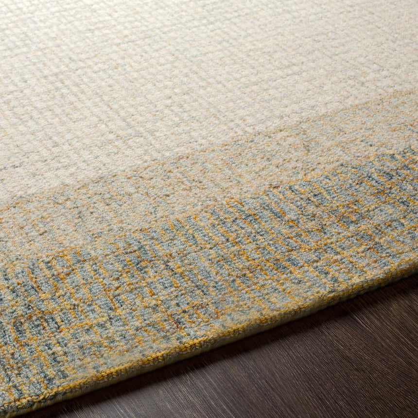 Close-up of the hand-tufted Tandayag Area Rug. Cream, light beige, and sage wool rug with a subtle striped pattern. Texture