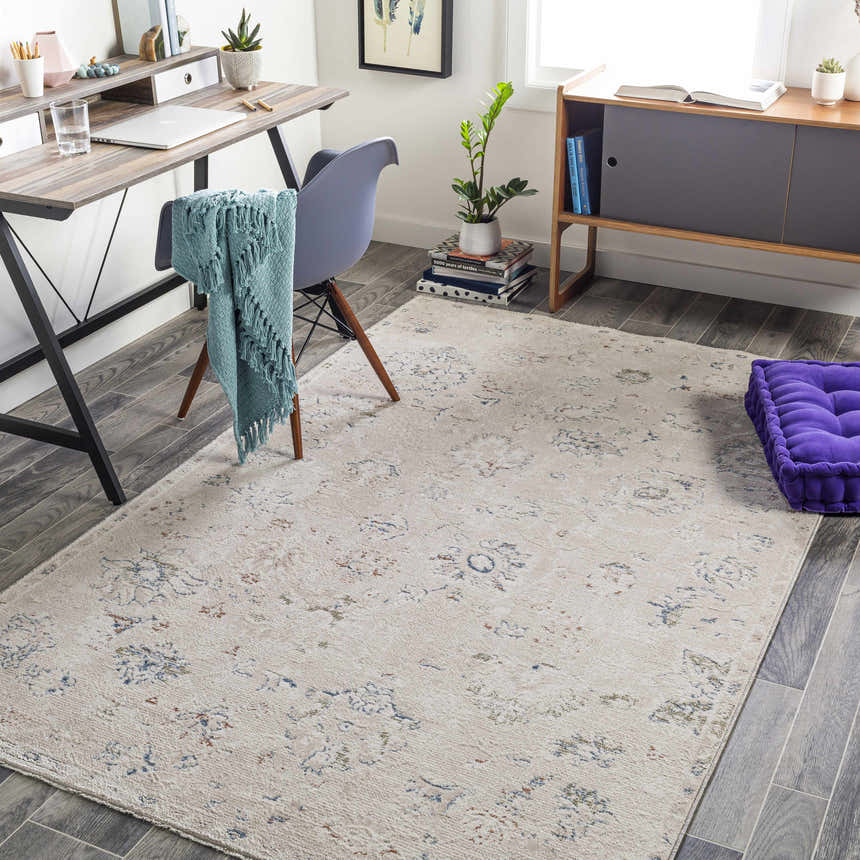 Home office with a light gray Tinampo Area Rug, desk, chair, and purple cushion. Roomscene-Rectangle