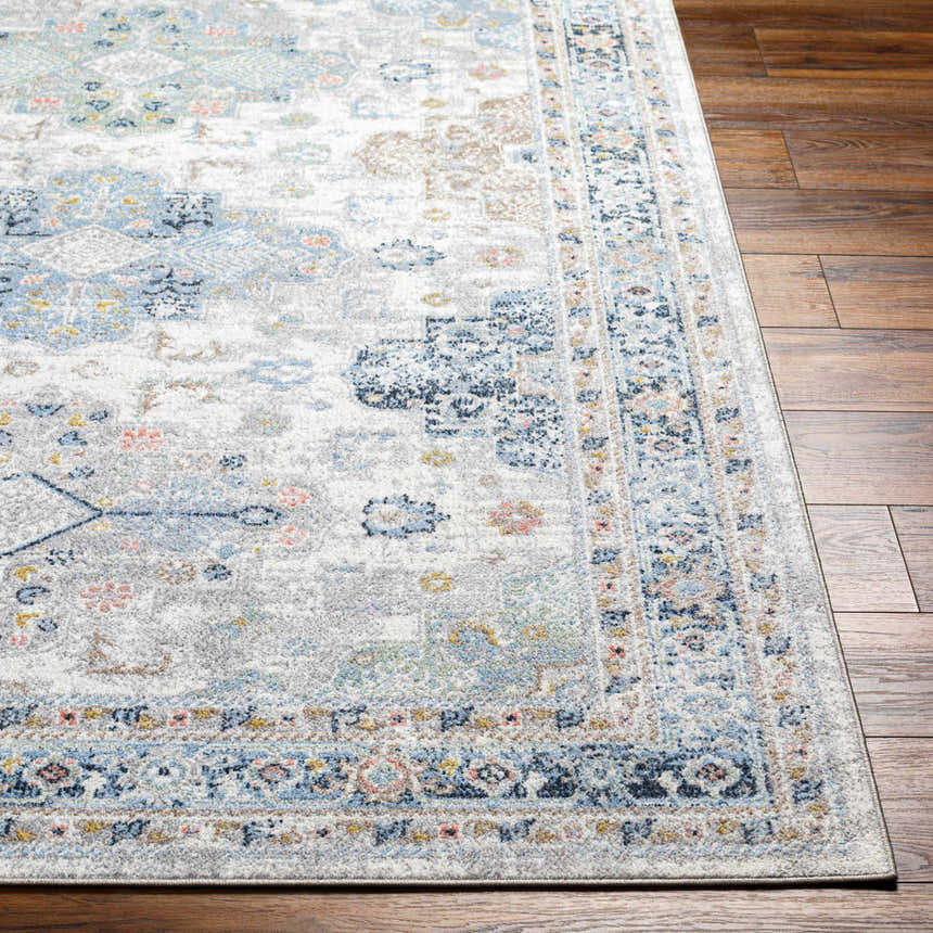 Close-up of the Tana Washable Area Rug in Arctic Stone, showing its traditional pattern and soft texture on hardwood floor. Front