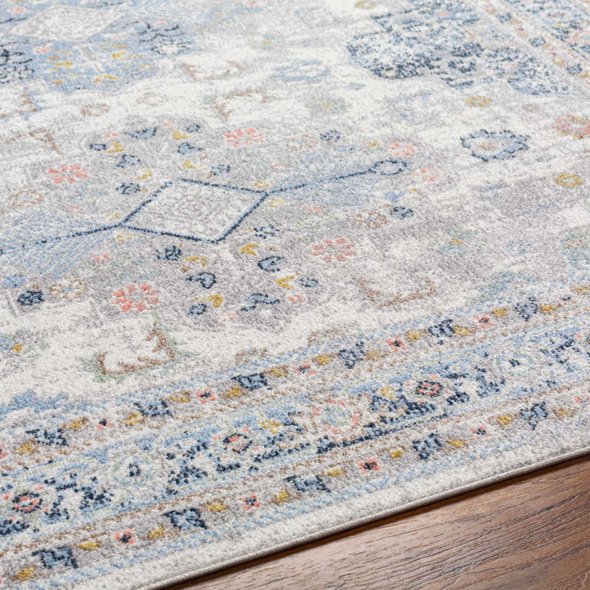 Close-up of the Tana Washable Area Rug in Arctic Stone, showing traditional floral and geometric patterns. Texture