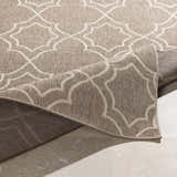 Close-up of the Toledo Area Rug, showcasing its beige and brown geometric pattern and machine-woven texture. Fold