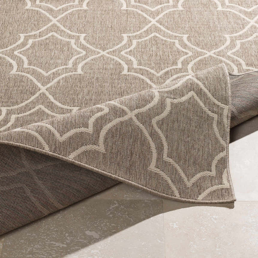 Close-up of the Toledo Area Rug, showcasing its beige and brown geometric pattern and machine-woven texture. Fold