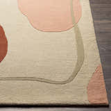 Close-up of the Tomingad Area Rug. Hand-tufted wool rug with a geometric design in brick red, dusty pink, oatmeal, and taupe. Front