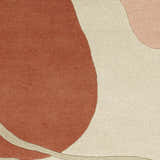 Close-up of the Tomingad Area Rug. Hand-tufted wool rug with brick red, oatmeal, and dusty pink geometric shapes. Swatch