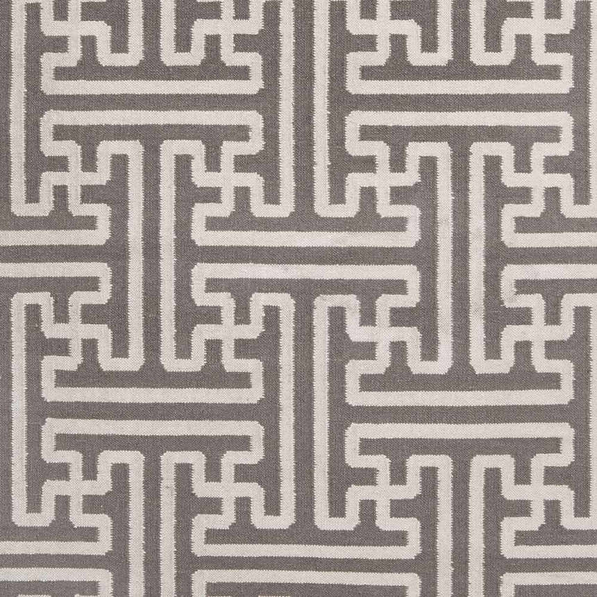 Close-up of the Tooele Area Carpet showing a cream geometric pattern on a tan, hand-woven wool texture. Swatch