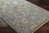 Close-up of the aqua Toquerville Premium Rug showing its floral, traditional pattern and viscose texture on dark wood floors. Corner