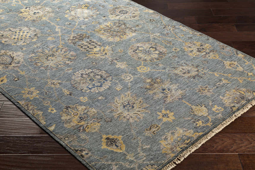 Close-up of the aqua Toquerville Premium Rug showing its floral, traditional pattern and viscose texture on dark wood floors. Corner