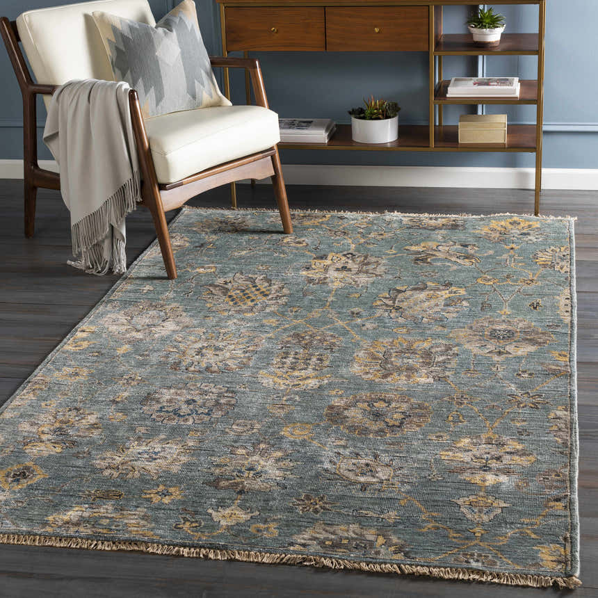 Living room scene with aqua Toquerville Premium Rug, white chair, wood console table, and blue wall. Roomscene-Rectangle