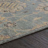 Close-up of the Toquerville Premium Rug. Aqua, charcoal, and oatmeal floral pattern on a hand-knotted viscose rug. Texture