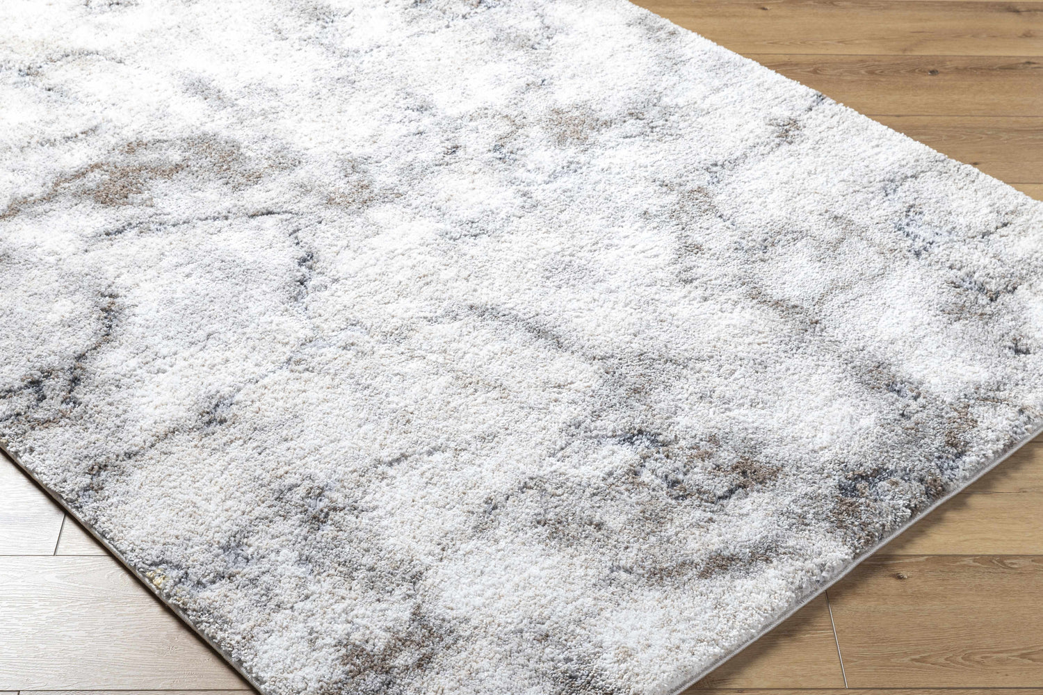 Close-up of the Titan Light Gray Area Rug showing its silver and gray contemporary pattern and soft texture. Corner