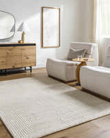 Living room scene with ash and off white Tyrus area rug, wood cabinet, and neutral chairs. Roomscene-Rectangle