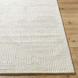 Close-up of the hand-tufted Tyrus Area Rug. Ash, light silver, and off-white geometric square pattern in 100% wool. Front