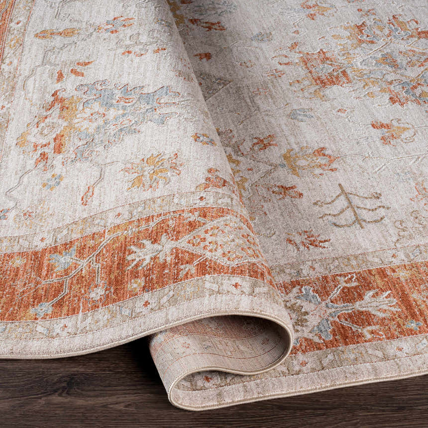 Close-up of the Tsawwassen Thick Luxe Area Rug showing brick red, light beige, and charcoal oriental pattern. Fold
