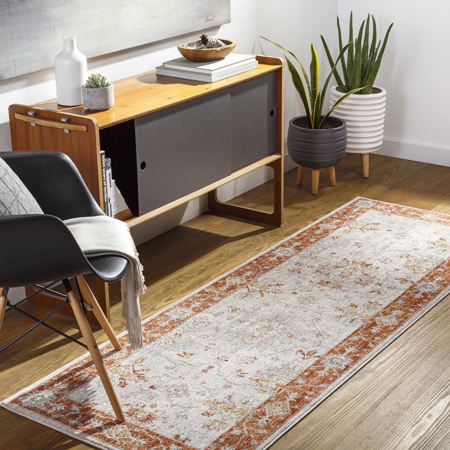 Hallway scene with a Tsawwassen Thick Luxe Area Rug runner in brick red and light beige, styled with mid-century modern furniture. Roomscene-Runner