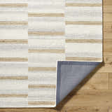 Close-up of the Toren Broken-Striped Area Rug showing ash, pearl, and prairie dust stripes. Hand-tufted wool texture visible. Fold