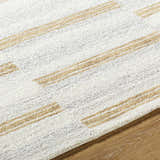 Close-up of the Toren Broken-Striped Area Rug. Ash, pearl, and prairie dust stripes on a hand-tufted wool rug. Texture