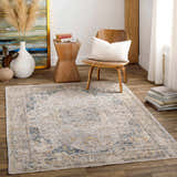 Living room scene with a beige, blue, and mustard Tuganay Luxe Performance Rug adding a bohemian touch. Roomscene-Rectangle