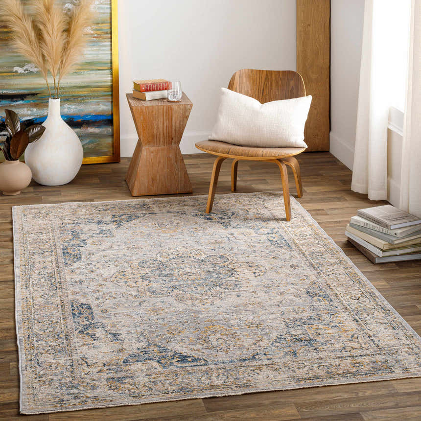 Living room scene with a beige, blue, and mustard Tuganay Luxe Performance Rug adding a bohemian touch. Roomscene-Rectangle