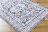 Close-up of Terri Washable Area Rug in beige, black, cream, dark red and gray with a traditional pattern. Corner