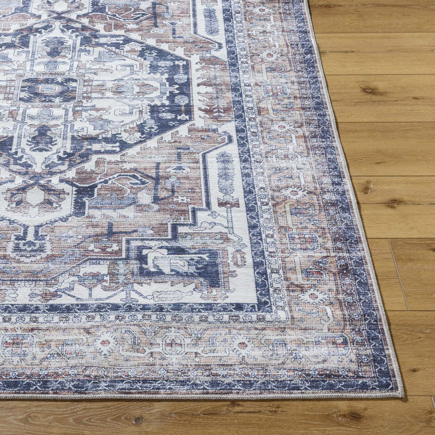 Close-up of Terri Washable Area Rug in beige, black, cream, and gray with a traditional, farmhouse-inspired pattern. Front