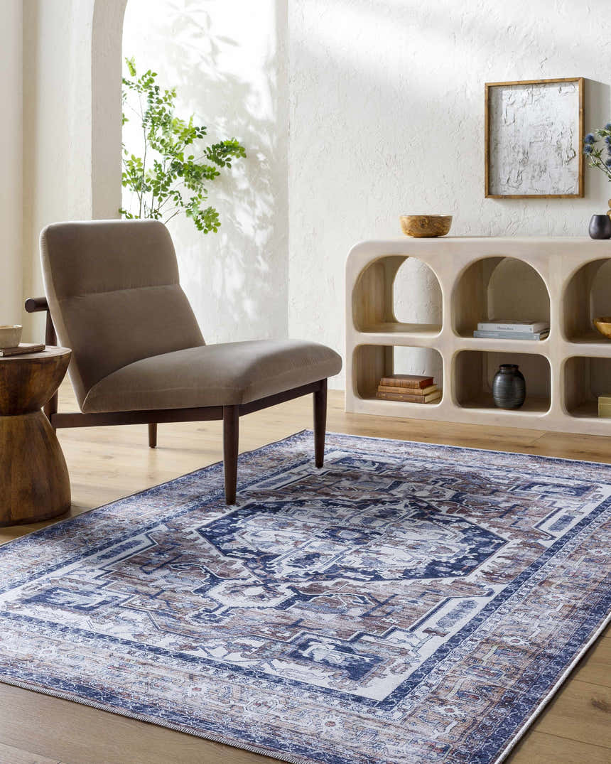 Living room scene with Terri Washable Area Rug in beige, black, and blue. Farmhouse style with chair and wood accents. Roomscene-Rectangle