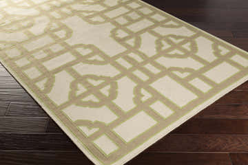 Close-up of the Ucon Area Rug. Light brown trellis pattern on a light beige wool rug with light olive accents. Hand woven texture. Corner