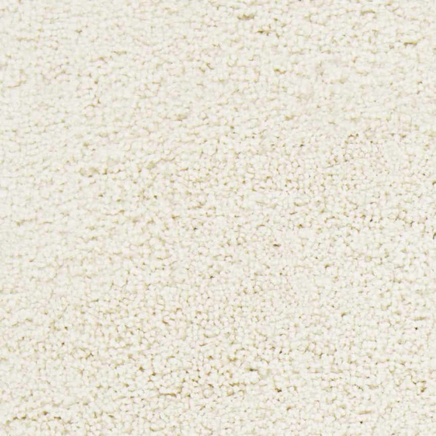 Close-up of the cream Umpire Area Rug, a hand woven shag rug with a soft, textured pile. Swatch