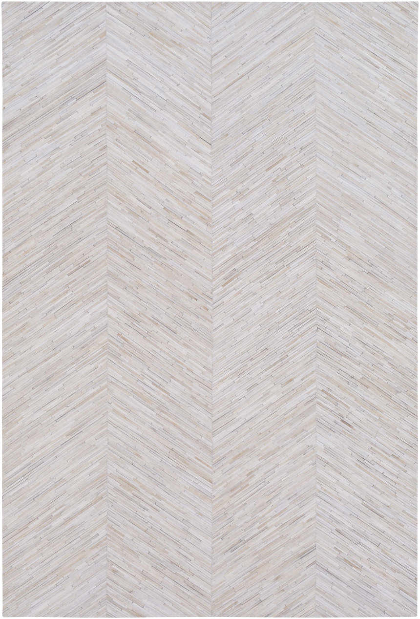 Close-up of the Upland Premium Rug. Brown, cream, and gray hair on hide forms a contemporary chevron pattern. Design-Rectangle-58