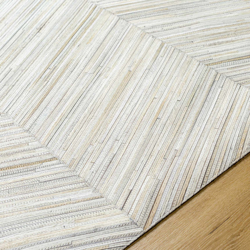 Close up of the hand crafted Upland Premium Rug. Brown, cream, and gray hair on hide rectangular design. Texture