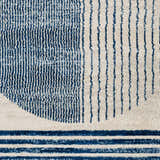 Close up of the Usra Area Rug featuring a blue and white geometric pattern. Swatch