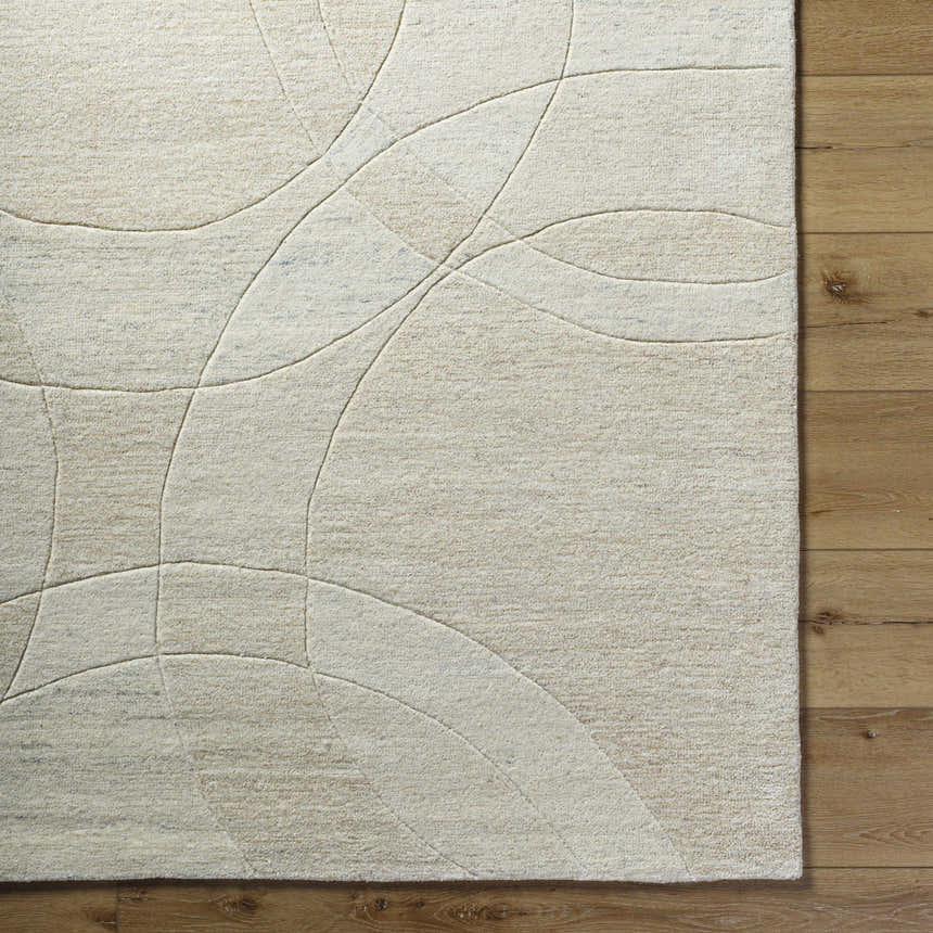 Close-up of light silver Ville Modern Wool Rug with a contemporary geometric design on a wood floor. Corner