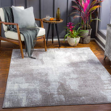 Living room scene with a charcoal and cream Victorias Area Rug, wood chair, and side table. Roomscene-Rectangle