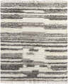 Close-up of the Vida Area Rug, a hand-woven shag rug with cream, taupe, and dark brown horizontal stripes and fringe. Design-Rectangle-810