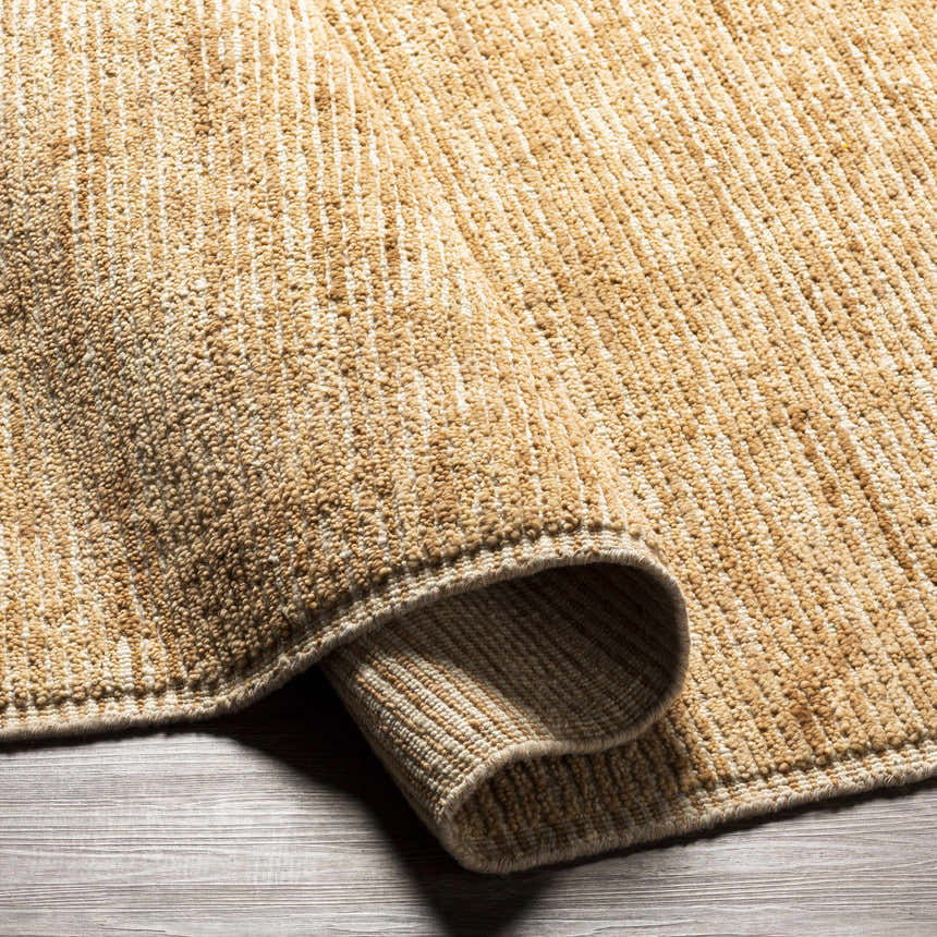 Close-up of the hand-loomed Vezirhan Area Rug. The rug is dark red and peach, made of cotton and wool with a contemporary style. Fold