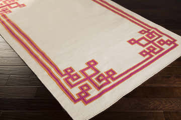 Close-up of the Vliets Clearance Rug, a hand-woven wool runner with a pink and orange geometric border on dark wood floors. Corner