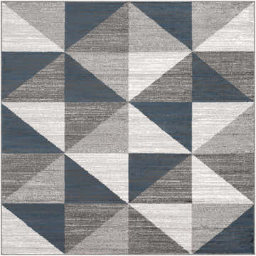 Close-up of the Volant Area Rug featuring a geometric triangle pattern in blue, charcoal, gray, and white. Design-Square-67