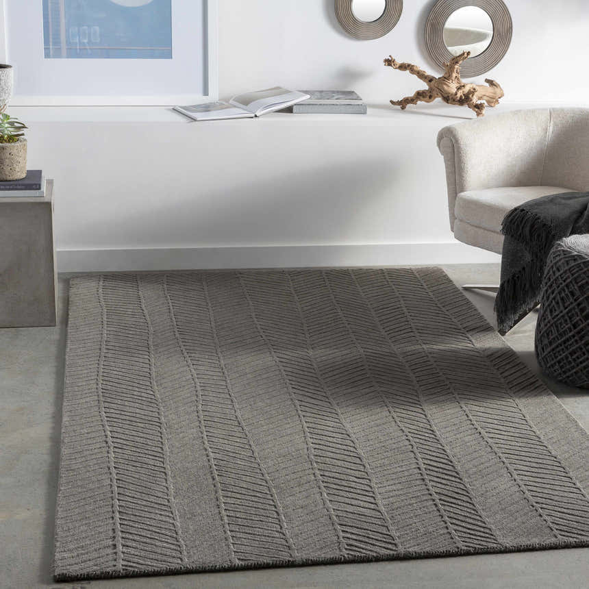 Living room scene with a charcoal Everson Carpet Area Rug, light chair, and modern decor. Roomscene-Rectangle