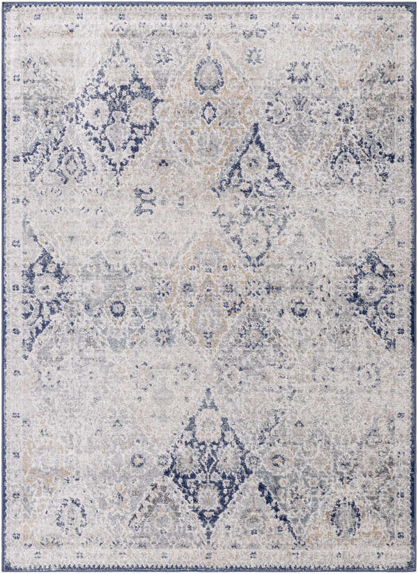 Close-up of the Valin Area Rug: a traditional, machine-woven rug in blue, charcoal, cream, and gray tones. Design-Rectangle-5373