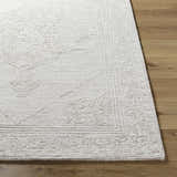 Close up of the ash Verne Area Rug showing its hand-tufted texture and traditional pattern on hardwood floor. Front