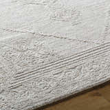 Close-up of the ash-colored Verne Area Rug. Hand-tufted wool rug with farmhouse style design and subtle geometric pattern. Texture