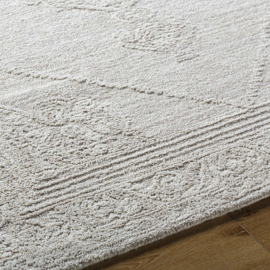 Close-up of the ash-colored Verne Area Rug. Hand-tufted wool rug with farmhouse style design and subtle geometric pattern. Texture
