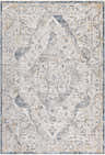Close-up of the Wadeye Luxe Fringe Rug, a machine-woven rug with a traditional pattern in dark blue, gray, and mustard tones. Design-Rectangle-6796