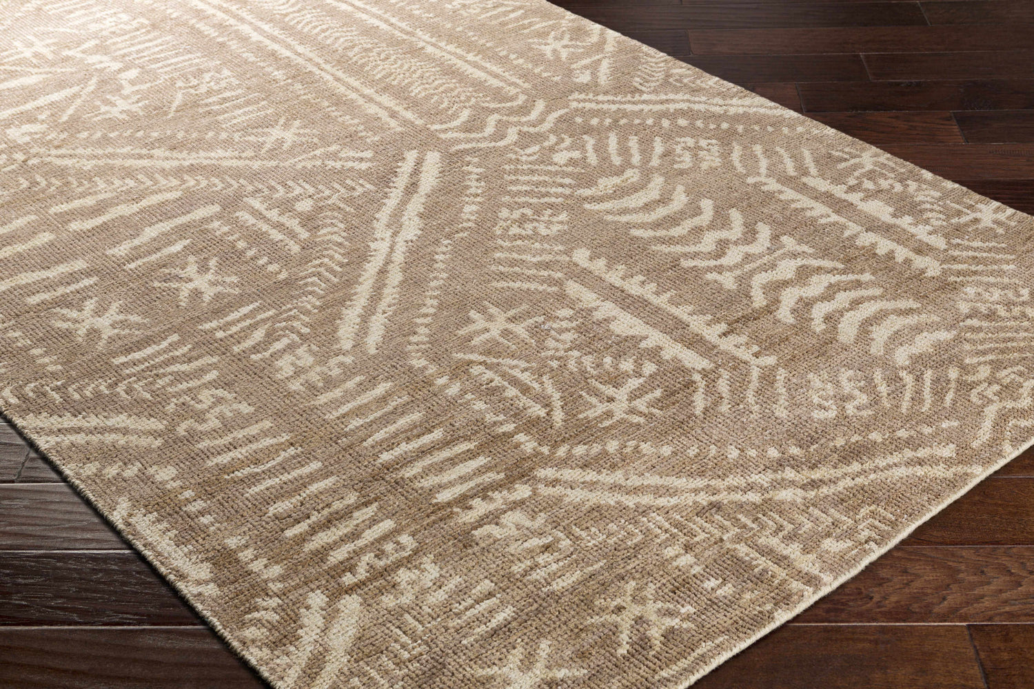 Close-up of the Wainfleet Jute Carpet showing its hand-knotted construction and farmhouse-style geometric pattern in beige and cream. Corner