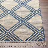 Close-up of the hand woven Walgett Carpet Area Rug. Blue and cream diamond pattern with fringe detail. Front