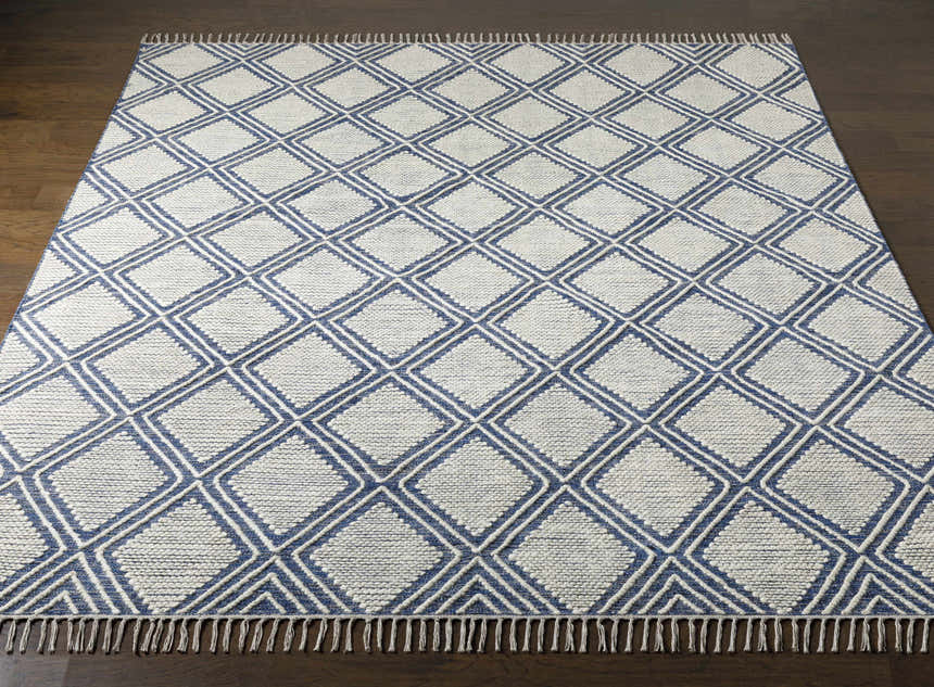 Close-up of the hand woven Walgett Carpet Area Rug. Features a blue diamond pattern on cream cotton. Front