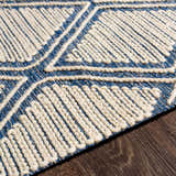 Close-up of the hand woven Walgett Carpet Area Rug. Blue cotton rug with cream geometric pattern and textured detail. Texture