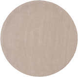 Close-up of a round Brockton Solid Tan Area Rug. The rug has a subtle striped texture and is hand loomed from 100% wool. Design-Round-6